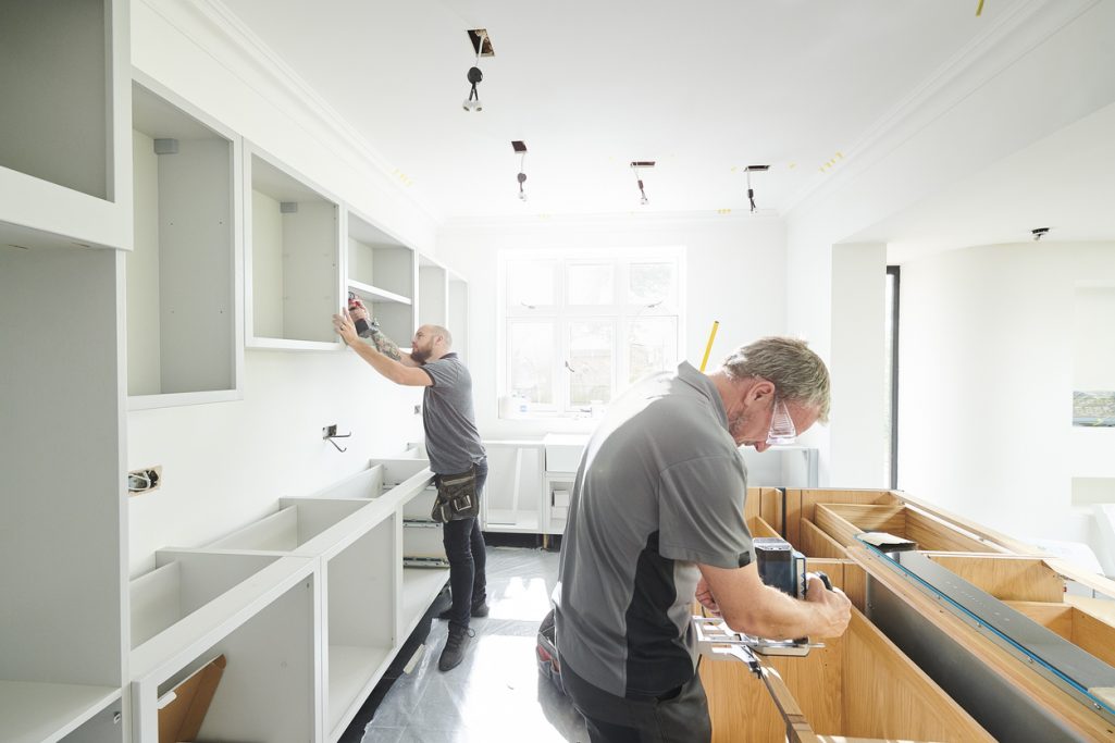 Joinery team fitting a new construction home kitchen
